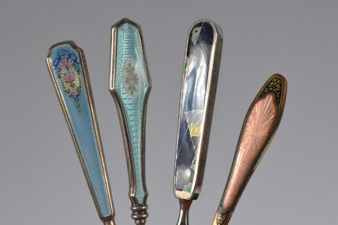 Four sets of matching enamel handled shoehorn and button hooks