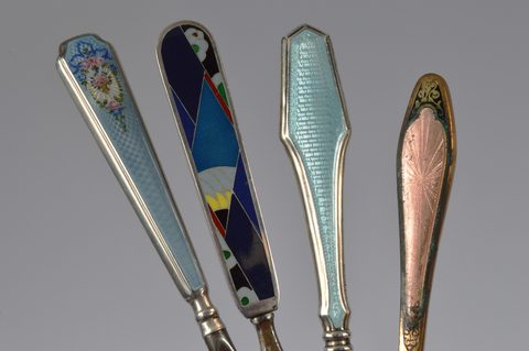 Four sets of matching enamel handled shoehorn and button hooks