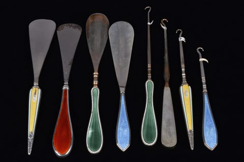 Four sets of matching guilloche enamel silver handled button hooks and shoehorns