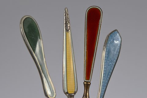 Four sets of matching guilloche enamel silver handled button hooks and shoehorns