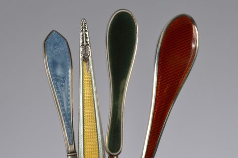 Four sets of matching guilloche enamel silver handled button hooks and shoehorns