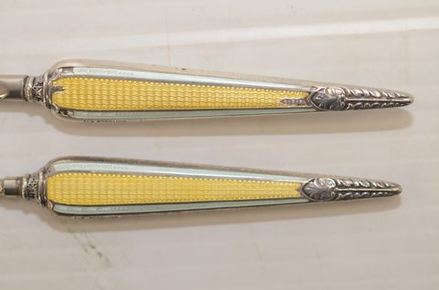 Four sets of matching guilloche enamel silver handled button hooks and shoehorns