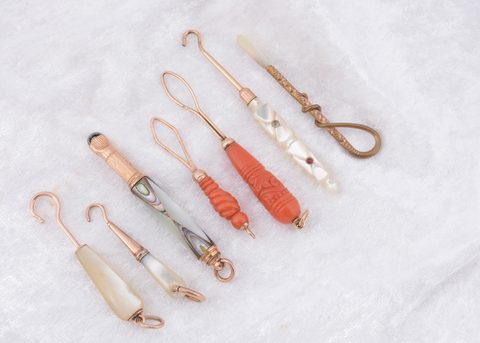 Seven organic and gilt metal button loops and hooks