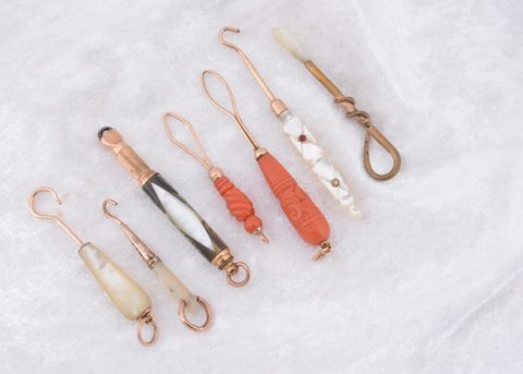 Seven organic and gilt metal button loops and hooks