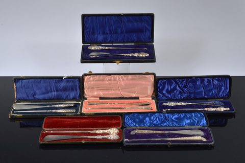Six cased silver handled button hook and shoehorn sets