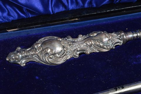 Six cased silver handled button hook and shoehorn sets