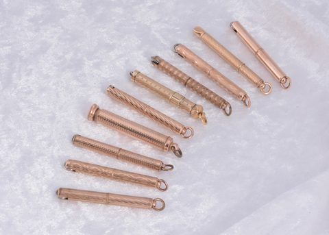 Ten gilt metal protracting and pull out sleeve button hooks