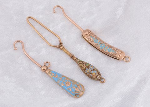 Three blue enamel and yellow metal button loops and hooks