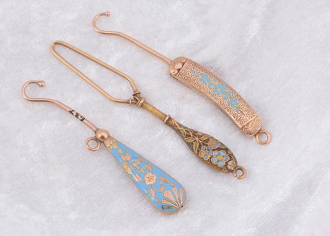 Three blue enamel and yellow metal button loops and hooks