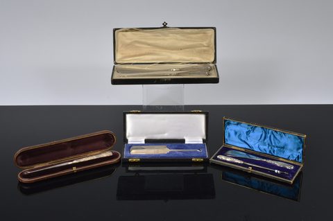 Three cased silver handled button hooks and shoehorns