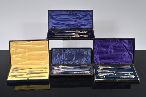 Three cased silver handled four piece dressing table sets
