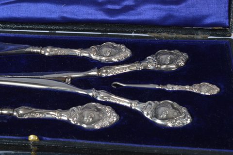 Three cased silver handled four piece dressing table sets