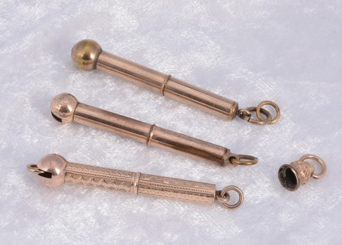 Three gilt metal protracting button hooks