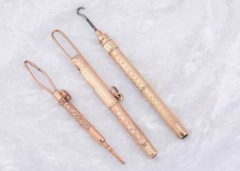 Three gold plated Edwardian button hooks
