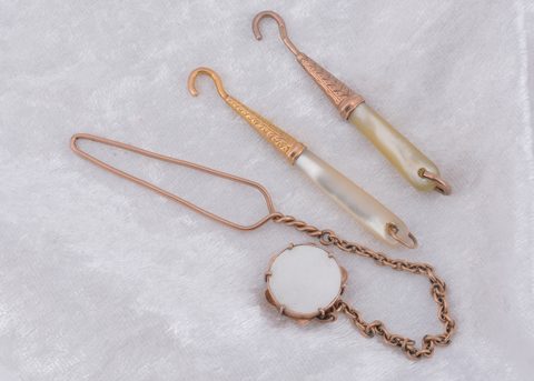 Three mother of pearl button loops and hooks