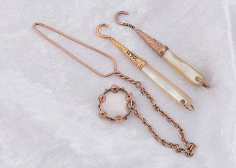 Three mother of pearl button loops and hooks