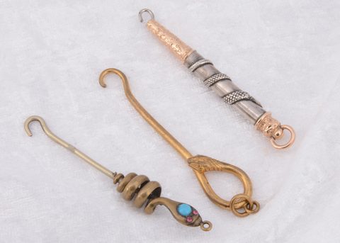 Three serpent style button hooks