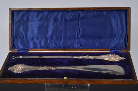 Two cased silver handled button hook and shoehorn sets