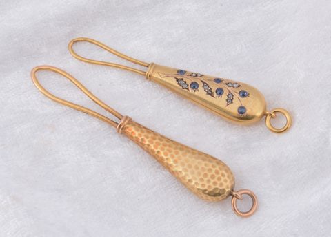 Two continental yellow metal button loops