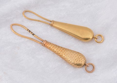 Two continental yellow metal button loops