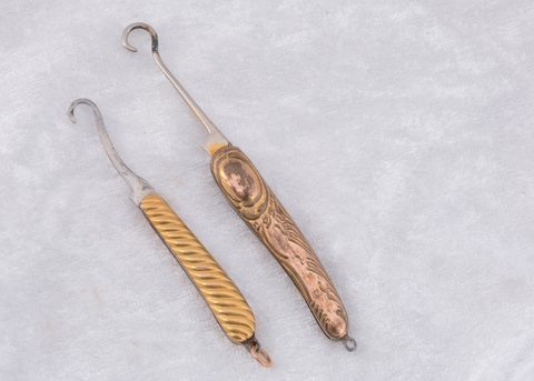 Two Edwardian gold plated folding button hooks