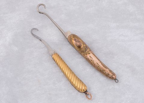 Two Edwardian gold plated folding button hooks