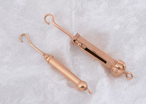 Two gilt metal retractable fob button hooks