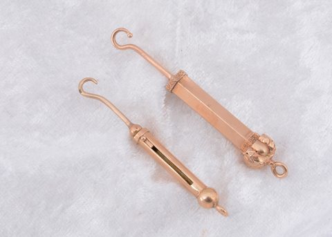 Two gilt metal retractable fob button hooks