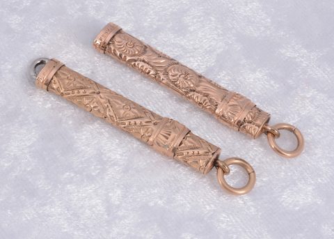 Two gilt metal slide button hooks