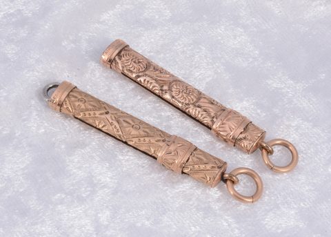 Two gilt metal slide button hooks