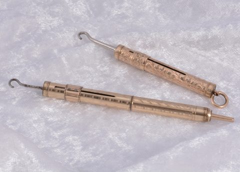 Two gilt metal sliding button hooks