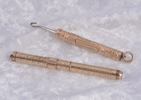 Two gilt metal sliding button hooks