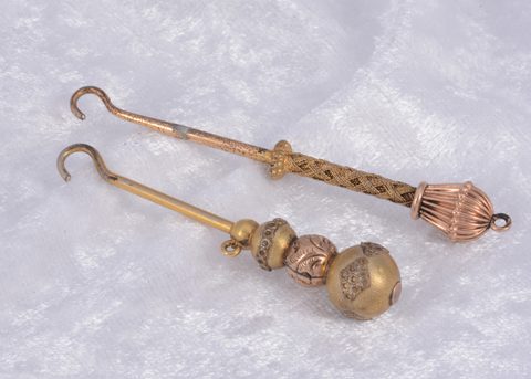 Two gold plated button hooks