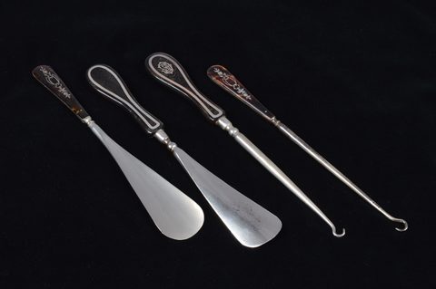 Two sets of matching button hooks and shoehorns