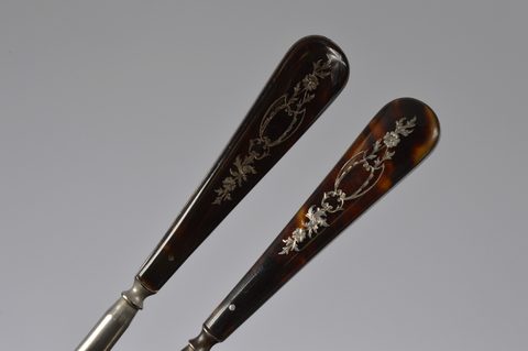 Two sets of matching button hooks and shoehorns